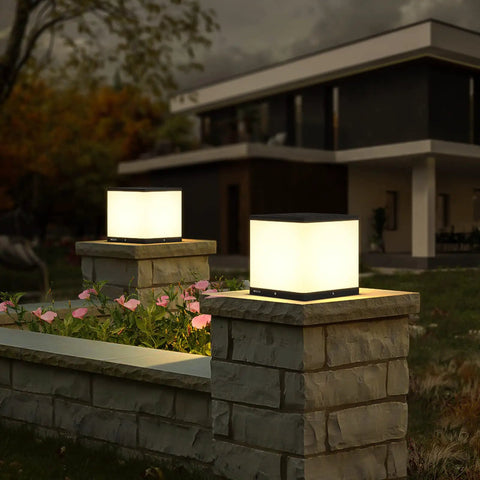 Outdoor Solar Post Cap Light With Warm 3000K LED IP54 Waterproof Energy Saving 9.8 Inches Ideal For Fence Deck Garden Or Patio Posts Modern Luxury Die Cast Stainless Steel No Fuss Install illuminating a stone fence at night.