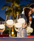 7 Piece Battery Operated Flameless LED Candles With Remote Timer, Waterproof on wine glasses at outdoor wedding