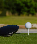 Close-up of a golf club and ball on tee, outdoors on Beefy Pro Grade Heavy Duty Golf Practice Mat 1 Foot By 3 Foot Hitting Strip