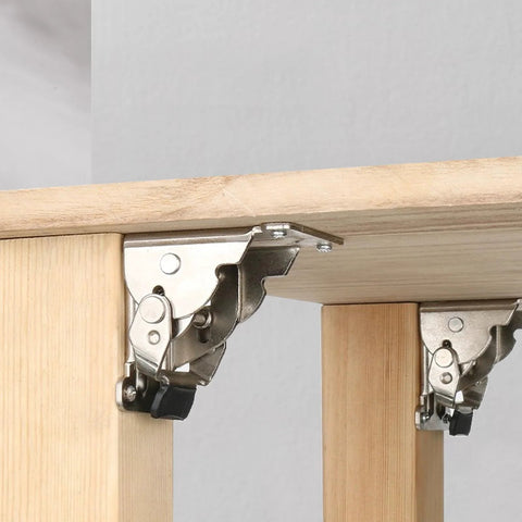 Heavy duty folding table leg brackets on wooden desk, showing silver steel construction with self-locking mechanism at 0 and 90 degrees.