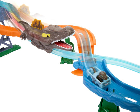 Hot Wheels RacerVerse Jurassic World Crash And Splash Playset With Die Cast Velociraptor Vehicle racing past Spinosaurus