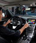 Driver using Wireless CarPlay and Android Auto Interface for Cadillac CTS 2009-2013 Retrofit Kit with original camera support.