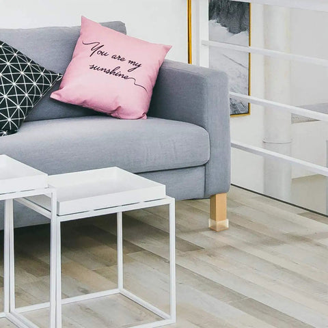 Square Table Leg Protectors For Large Chairs And Sofas Fits From One And Fifteen Sixteenths Inches To Two And One Sixteenth Inches 49mm To 53mm Two Inch Silicone Leg Caps With Felt Pads Clear 16 Pack No Slip Floor Safe Easy Fit on a sofa leg in a modern living room