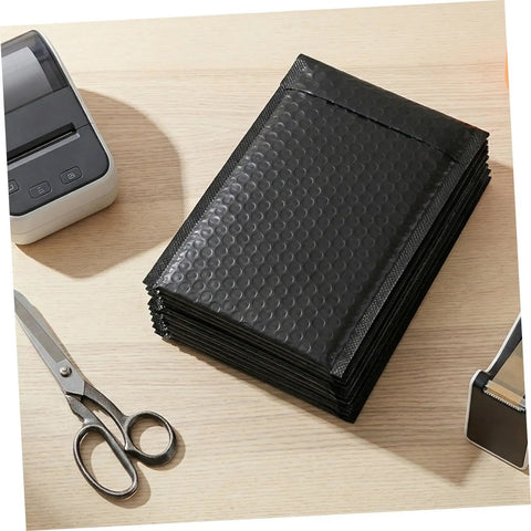 60 Pack Black Self-Sealing Bubble Mailers With Tear-Resistant PET Padding For Electronics And Cosmetics on desk