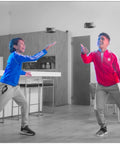 Two kids playing indoors with Gravitor Hand Controlled Flying Toy With Trick Stick USB Rechargeable Drone For Kids 4 And Up Wave Control Hover Toy That Senses Altitude No Remote Needed