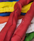 Multiple industrial slings in various colors, including red, yellow, and purple, stacked; Endless Purple Polyester Round Sling visible