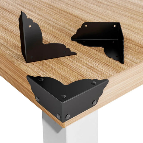 Top Notch Eight Piece Antique Bronze Corner Protectors, 70x70x26 mm, metal edge guards on wooden table corners.