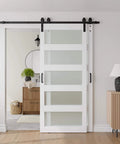 Front view of Double Bypass Barn Door With Frosted Glass And White Waterproof PVC Finish Includes Six Point Six Feet Track Hardware Kit Premium MDF Panels For Space Saving And Easy Assembly Fits Thirty Six By Eighty Four Inch Openings installed in a living room.