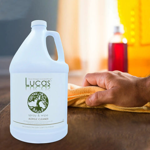 Acrylic Cleaner Spray For Plexiglass And Non Porous Surfaces Streak Free Ready To Use Formula Alcohol And Ammonia Free For Windows Mirrors Electronics Salon And Spa Safe Tanning Bed Friendly 1 Gallon bottle on table with hand wiping surface