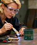 Person using Nozzle Cleaner Gel 200g for welding spatter and flux removal in a workshop setting