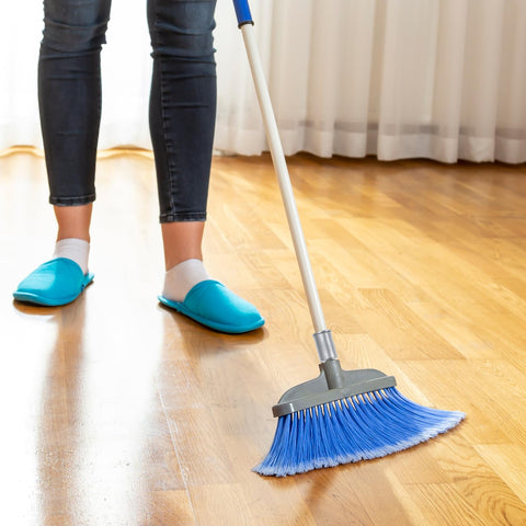 Person sweeping floor with broom using Heavy Duty Aluminum Threaded Tips For Extension Poles And Push Broom Handles