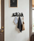 Wall Mounted Key Holder With 7 Dope Black Metal Hooks, Mountain Themed Key Rack with towels and bag, rustic home decor on wall.