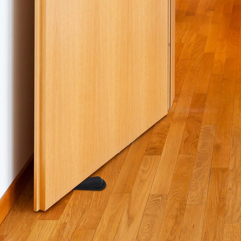 A wooden door with 2Pcs Black Rubber Door Stopper Wedge With Antislip Surface For Bedroom Or Office Use Easy Toolless Installation beneath.