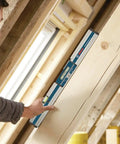 Person using GIM 60 24 Inch Digital Level with Illuminated Rotating Display on wooden beam at construction site