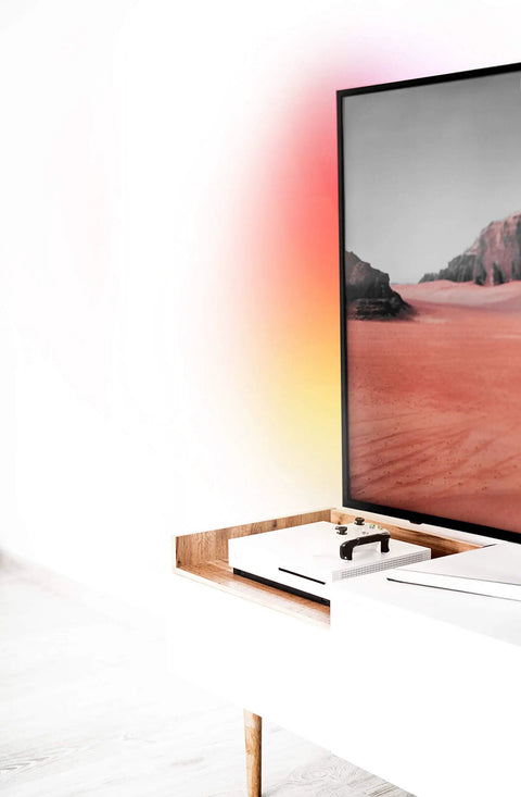 Z TV LED Light Strip Multicolor Kit with Wi Fi Control on TV creating ambient glow around desert image on screen, no hub needed