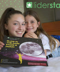 Two children holding Glow In The Dark Ceiling Stars And Moon Wall Decals for Kids Bedroom or Nursery package with moon graphic