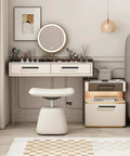 Vanity desk setup with drawers and stool in a modern bedroom