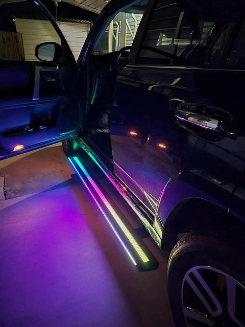 Slick Electric Deployable Running Boards For Tesla Cybertruck Heavy Duty Cast Aluminum Side Steps with multicolor lighting effect.