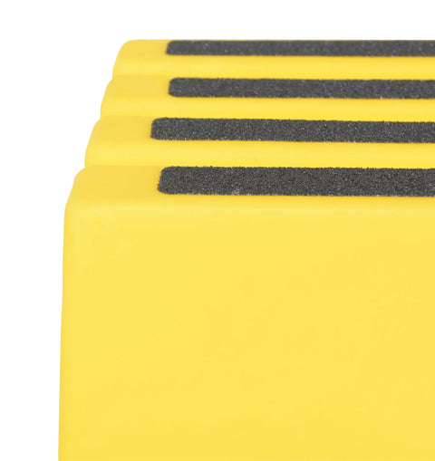 Close-up of non-slip tape surface on yellow polyethylene one-step stool with rubber feet for easy access anywhere in home or workshop