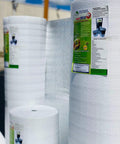 Heavy Duty Three Millimeter Foam Core Radiant Barrier Roll Blocks Summer Heat Silences Room Echoes White Vinyl Surface stacked.