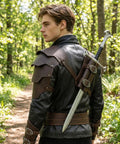 Man wearing Two In One Medieval Shoulder Armor With Back Sword Frog Holder Pauldrons And Sword Holster For Knight LARP Cosplay Renaissance Prop Made From Premium Faux Leather With Brass Rivets in forest