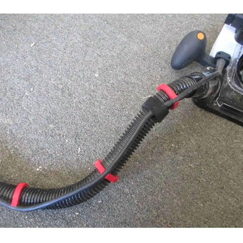 Tear Up Cord Chaos And Tangled Hoses With This Eight Pack Snap Clip Set holding vacuum hose tightly on carpet.