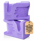 High Density Yoga Blocks Pair Ergonomic Wrist Support Hand Shaped Non Slip Surface Super Comfy Smooth Grip Zero Joint Kinks Forty Five Degree Alignment For Pilates And Stretching Sessions in purple color.