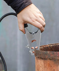 Heavy Duty Welding Ground Clamp With Super Firm Grip And Stable Conductivity For Professional Projects featuring a hand gripping the clamp on a metal surface.