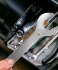 Hand holding 4 In 1 Bike Headset Wrench Spanner Set with 30 32 36 40mm sizes, nickel plated, for quick disassembly in a tool kit.