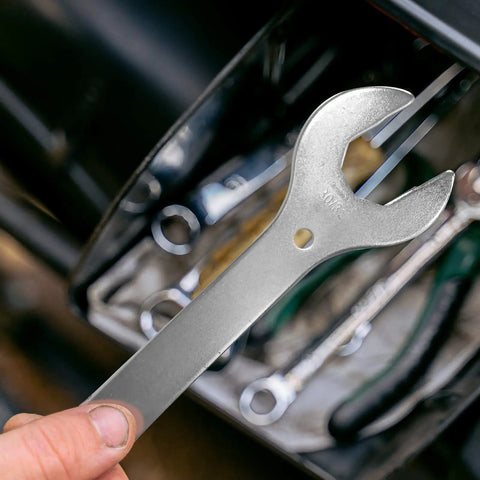 Hand holding 4 In 1 Bike Headset Wrench Spanner Set with 30 32 36 40mm sizes, nickel plated, for quick disassembly in a tool kit.