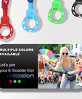 Colorful circular locks with advertisement for e-scooter trip featuring woman holding a scooter handlebar in a lively street scene.
