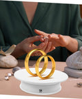 Rorpoir Adjustable Electric Rotating Display Stand For Jewelry And Watches With Anti Skid Base Energy Saving Motorized Turntable showcasing gold rings.