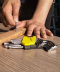 Person using Beefy 9 Piece Torx And Allen Wrench Set with Short Arm Hex Keys T10 to T50 on wooden board, chrome vanadium