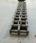 Top Tier 16B-2 Escalator Two Row Main Drive Chain With 25mm Pitch And Robust Roller Design on a flat surface.