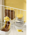 Hanging Gravity Pet Feeder Auto Water Dispenser No Drip Drinking Bowl Cage Mounted Food Dish For Dogs Cats Rabbits Heavy Duty Pp Plastic 37 Oz And 33 Oz Capacity Green Paw Friendly Chow Station in yellow on a wire cage.