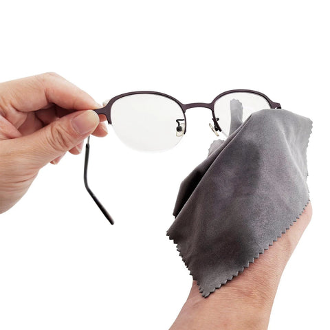 Xthel microfiber lens cleaning cloth used on eyeglasses, gray fabric wiping lenses
