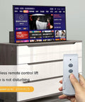 Beefy Electric TV Lift Stand With Smooth Remote Operation And Auto Memory Positions For Large Screens 26 To 65 Inches displayed with remote control.