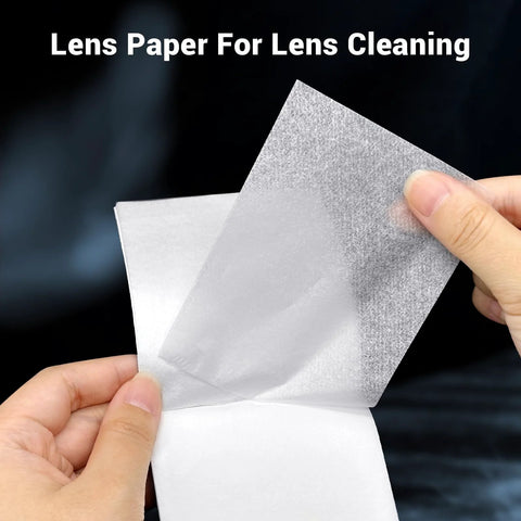 Lens cleaning tissue sheet; close-up view of hands peeling a translucent white sheet for camera and microscope lenses