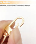 Top Tier Gold Metal Lobster Claw Clasps Featuring Smooth 360 Swivel Action With 20 Pack ready to use clasp held between fingers.