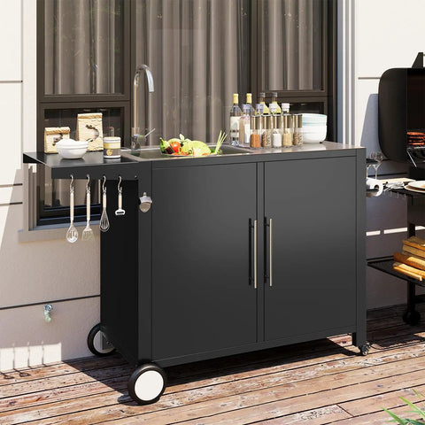 Outdoor Kitchen Sink With Hose Hookup And Stainless Steel Prep Table on wheels, set up on a patio with grilling items on top.
