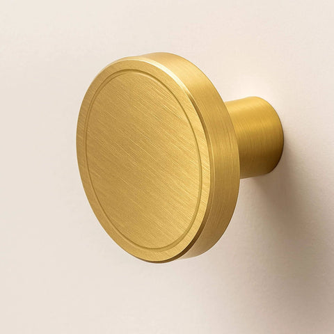 Side view of a 7 Pack Brushed Brass Cabinet Knobs 1 Inch Solid Round Gold Hardware For Cabinets Drawers And Vanity With Luxury Ring Carving Design