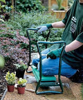 Heavy Duty Folding Garden Kneeler And Seat With Soft EVA Kneeling Pad Converts To Stool Or Bench, gardener using it among plants
