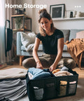 Woman organizing clothes in Foldable Trunk Organizer For Cars And SUVs With Dual Large Compartments And Six Mesh Pockets in living room.
