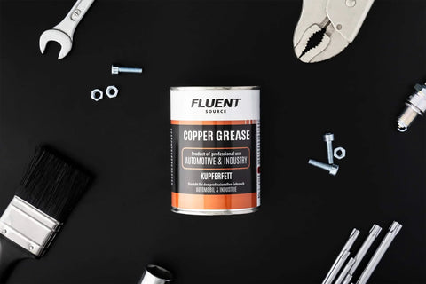 Copper Based Anti Seize Lubricant 11 Oz For High Temperature Fasteners Up To 1202 F surrounded by tools on black background