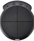 Top view of black compact electronic drum pad sound module with four velocity sensitive pads and control buttons visible