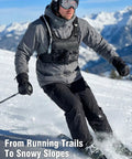 Man skiing wearing 2L Water Bladder Hydration Chest Pack For Running, Lightweight Vest, Black Camo, 12L M/L, snowy mountains