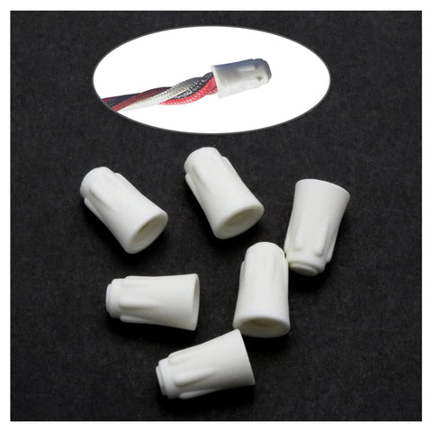 Top view of six small white ceramic wire connector caps for 22-14 AWG, 600V high-heat.