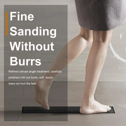 Person stepping on a 24 Inch Linear Shower Drain Tile in Grate Matte Black Floor Drain Kit No Flange with smooth finish.
