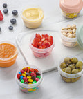 16 Pack 4 Ounce Reusable Plastic Jars With Lids For Snacks And Purees On The Go Salad Dressing Containers Deli Storage Freezer Baby Food Containers Dishwasher Safe And BPA Free filled with fruit, nuts, and olives