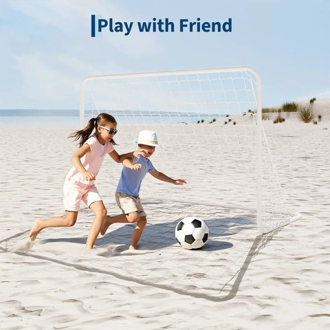 Kids playing soccer with Portable Backyard Soccer Goal 6x4 Ft With Net And Ground Stakes, Heavy Duty Steel Frame For Adults And Youth Practice, Training Drills, Easy Setup, Perfect For Backyard Games And Competitive Sessions on beach